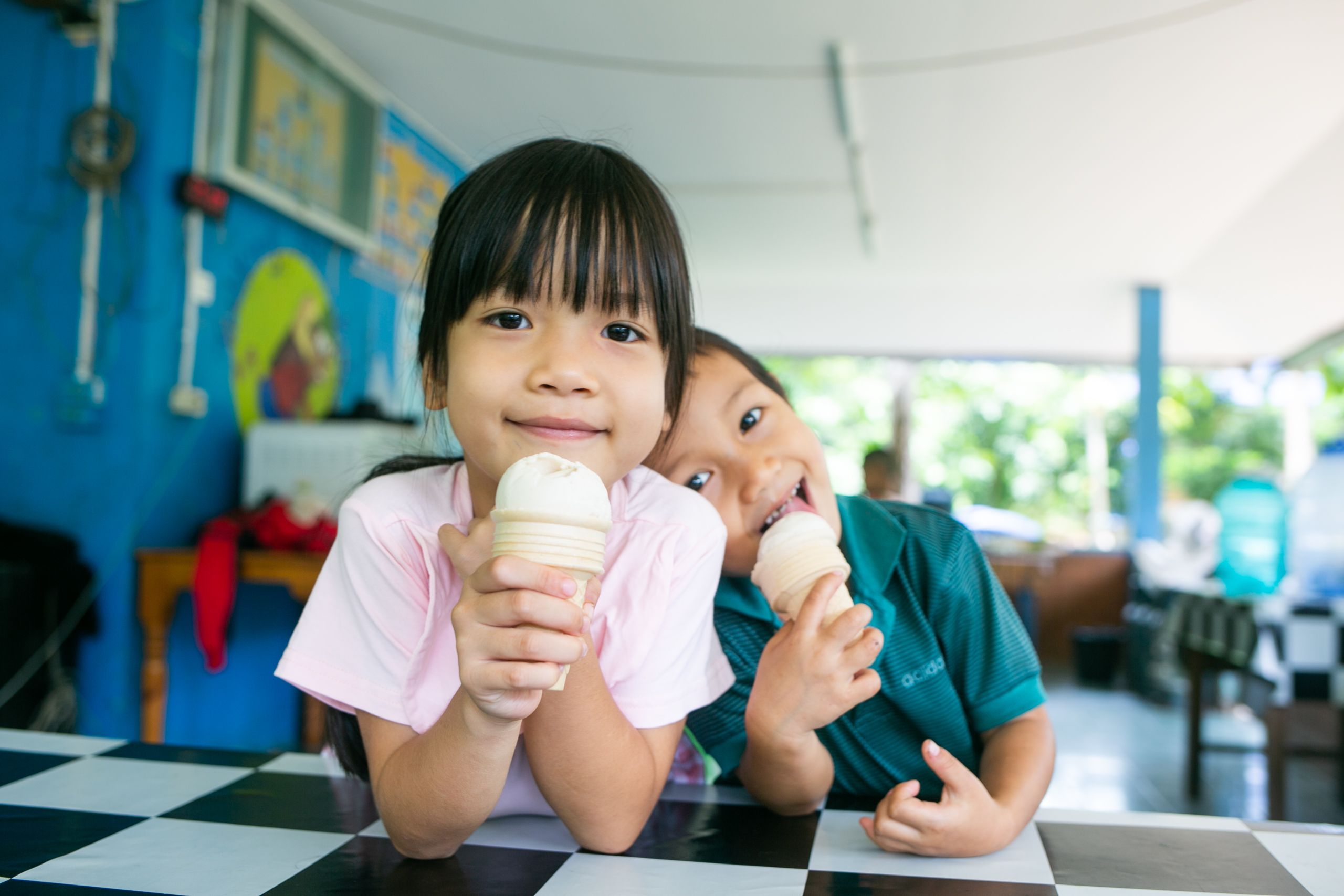 A portrait of Ai-Oon and BpiMai eating icecream